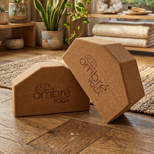 Load image into Gallery viewer, Tan cork yoga blocks set of two with ombré yoga logo, one resting on its side.