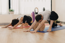 Load image into Gallery viewer, Two people doing yoga using Ombre Yoga&#39;s Harmony Cork Yoga Blocks