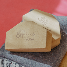 Load image into Gallery viewer, Beige angled ombré yoga cork blocks with embossed logo on gray mat